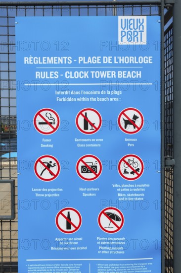 Posted rules sign with pictograms showing various restrictions at Clock Tower Beach, Old Port of Montreal, Quebec, Canada