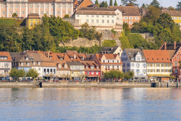 Historic row of houses on the lake with colourful architecture and autumnal trees, Meersburg, Lake Constance, Germany