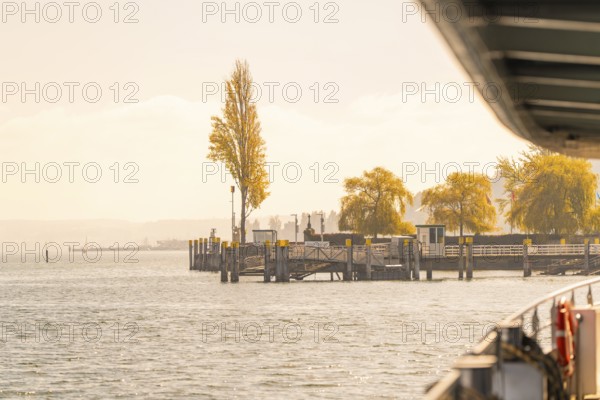 Quiet pier with autumn trees in the background, Mainau Island, Lake Constance, Germany