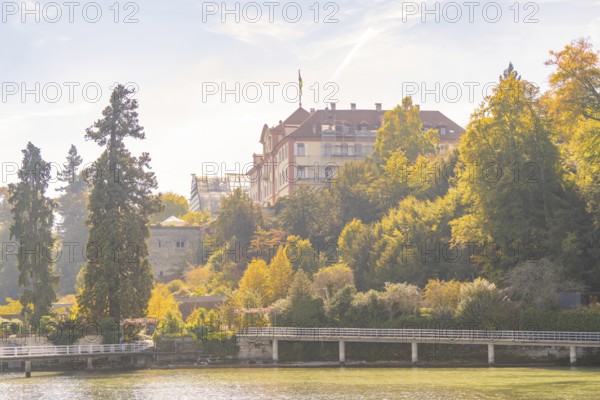 Castle on a wooded hill with autumnal trees, Mainau Island, Lake Constance, Germany