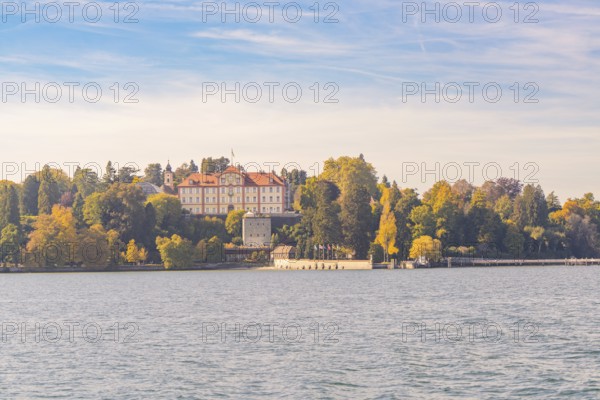 Sweeping view of the castle and autumnal forest by the lake, Mainau Island, Lake Constance, Germany