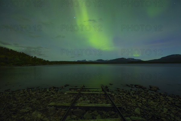 Magical northern lights over Lake Torneträsk at the boathouse