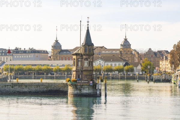 Striking tower in the water with historic buildings in the background, Constance, Lake Constance, Germany