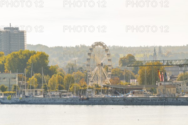 Harbour panorama with Ferris wheel and autumnal trees under a clear sky, Constance, Lake Constance, Germany