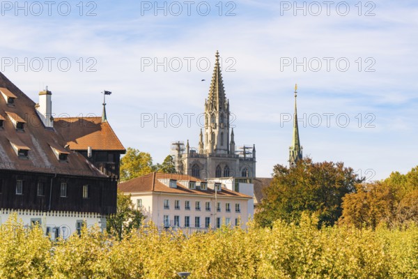 Historic church towers and buildings surrounded by autumn leaves under a clear sky, Constance, Lake Constance, Germany
