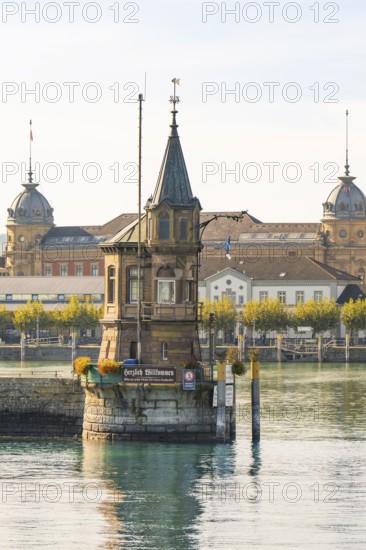 Historic tower on the water surrounded by autumnal city views, Constance, Lake Constance, Germany