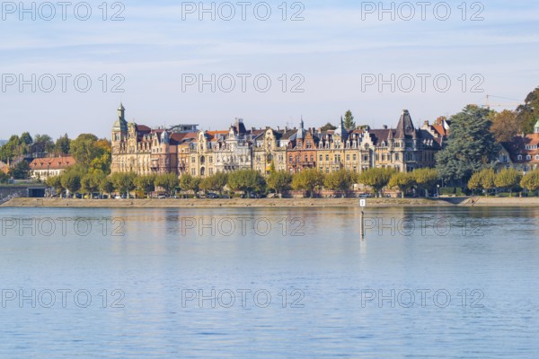 Victorian-inspired buildings along the promenade on a lake under a clear sky, Constance, Lake Constance, Germany