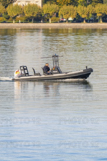 Small police motorboat on calm water with two people on board, Constance, Lake Constance, Germany
