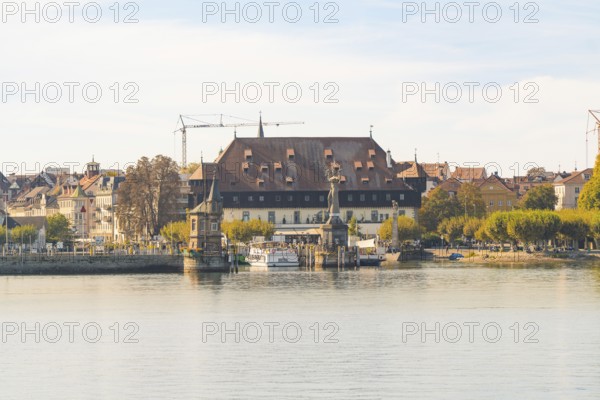 Historic riverside building with autumnal trees and peaceful atmosphere, Constance, Lake Constance, Germany