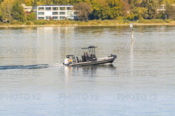 Fast police motorboat with two passengers travelling across the calm waters of a lake, Constance, Lake Constance, Germany