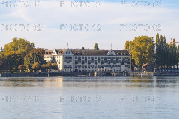 Historic architecture on the lakeshore, surrounded by autumnal trees, Constance, Lake Constance, Germany