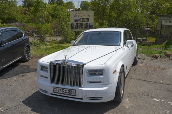A white Rolls-Royce in a car park under trees on a sunny day, Rolls-Royce Phantom VII, Aragazotn Province, Armenia