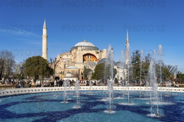 Fountain in Sultan Ahmet Park and the present-day mosque Hagia Sophia or Church of St Sophia, former Byzantine church and museum in Istanbul, Turkey