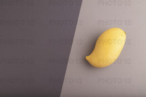 Orange mango on black and gray paper pastel background. Top view, flat lay, copy space. healthy food, minimalism