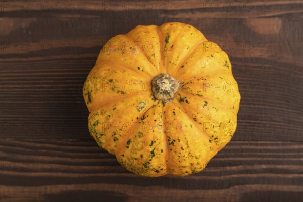 Orange Pumpkin on brown wooden background. Top view, copy space, flat lay. healthy food, vegetable, minimalism