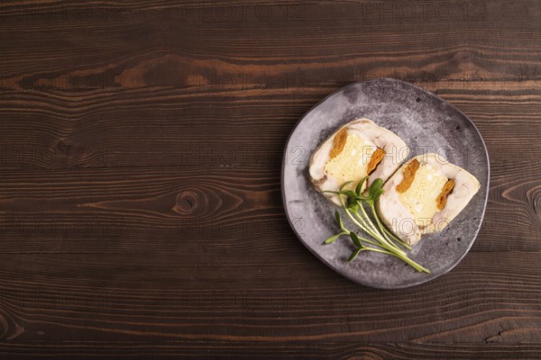 Chicken, egg and dried apricot meatloaf, microgreen on brown wooden. Diet, healthy eating. top view, copy space