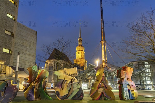 Artwork Graffiti, Pylon of the underground station Reinoldikirche and the city church St.Reinoldi at dusk, Dortmund, North Rhine-Westphalia, Germany