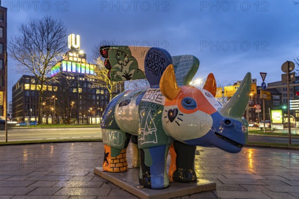The Winged Rhinoceros, heraldic animal and mascot of the concert hall Dortmund in front of Dortmund's landmark U, Centre for Art and Creativity at dusk, Dortmund, North Rhine-Westphalia, Germany