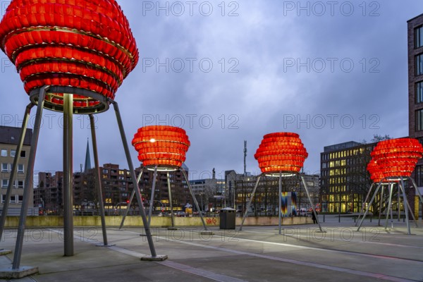 Illuminated sculptures of Dortmund roses in front of Dortmund's landmark U at dusk, Dortmund, North Rhine-Westphalia, Germany