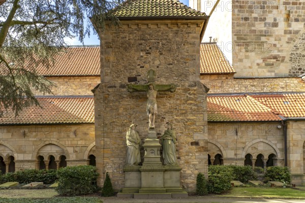 Inner courtyard with crucifix and cloister of St Peter's Cathedral in Osnabrück, Lower Saxony, Germany