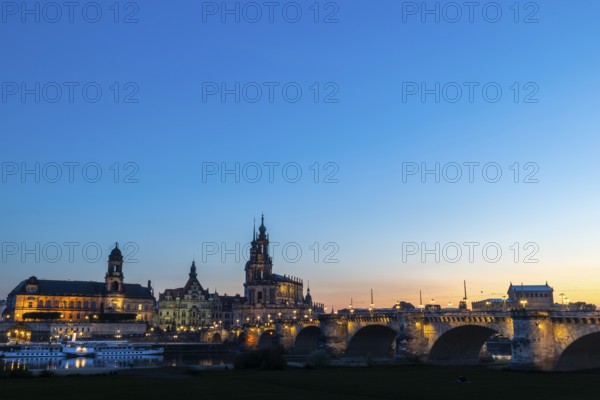 Old town skyline with Brühl's Terraces, Sanctissimae Trinitatis Cathedral, Court of Appeal, Royal Palace, Semper Opera House, Augustus Bridge, paddle steamer on the Elbe at dusk, Dresden, Saxony, Germany