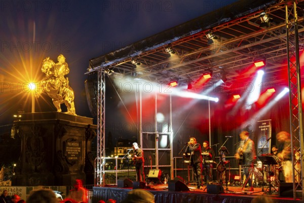 Equestrian statue of Augustus the Strong next to stage with musicians, Blue Hour, Neustadt, Dresden, Saxony, Germany