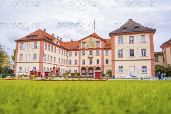 Historic castle with large lawn and sky in the background, Mainau flower island, Lake Constance, Germany