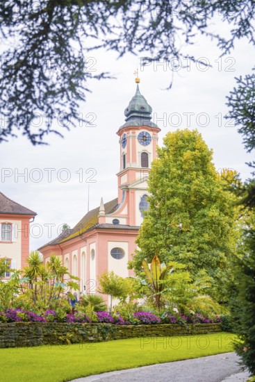 Historic church with beautiful garden in the foreground, Mainau flower island, Lake Constance, Germany