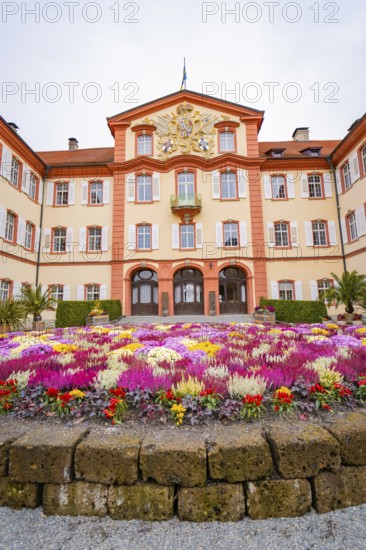 Symmetrical palace view with magnificent, colourful flowers, Mainau flower island, Lake Constance, Germany