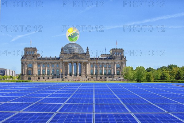 Symbolic image, solar park in the city, Reichstag building Berlin with environmental logo, modules on the green area, fictitious example photo, sensible use of space, renewable energy, green energy, hydropower, wind power, solar energy, solar power, photovoltaics, climate change, climate protection, CO2 emissions, ecology, greenhouse gases, Germany