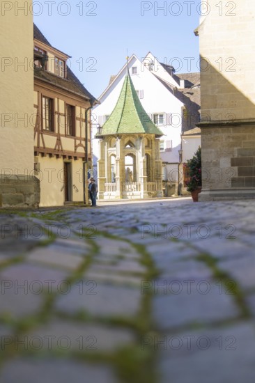 A quiet, narrow alley with cobblestones and historic buildings under a blue sky, Überlingen, Lake Constance, Germany
