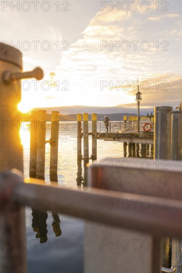 Sunset scene from a jetty overlooking a lake, Überlingen, Lake Constance, Germany