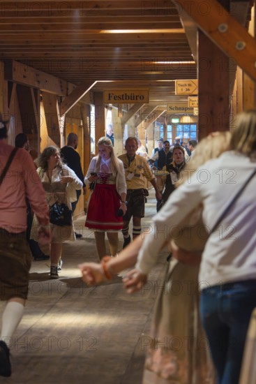 Interior shot of a marquee area with people in traditional Bavarian traditional costume, cheerful atmosphere, Cannstatter Wasen folk festival, Stuttgart, Germany