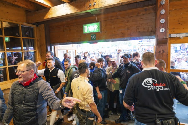 Crowd of people trying to get into the marquee, lively atmosphere, Cannstatter Wasen folk festival, Stuttgart, Germany