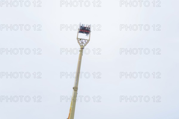 An attraction with people and a wide view of the sky, Cannstatter Wasen fair, Stuttgart, Germany