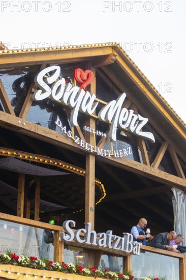 Wooden balcony with lettering in the evening mood and festive lighting, Cannstatter Wasen folk festival, Stuttgart, Germany