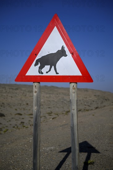 Sign warning of brown hyenas or beach wolves (Parahyaena brunnea) near Lüderitz, Karas Region, Namibia