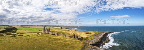 Panorama of Dunstanburgh Castle from a drone, Northumberland Coast, England, United Kingdom