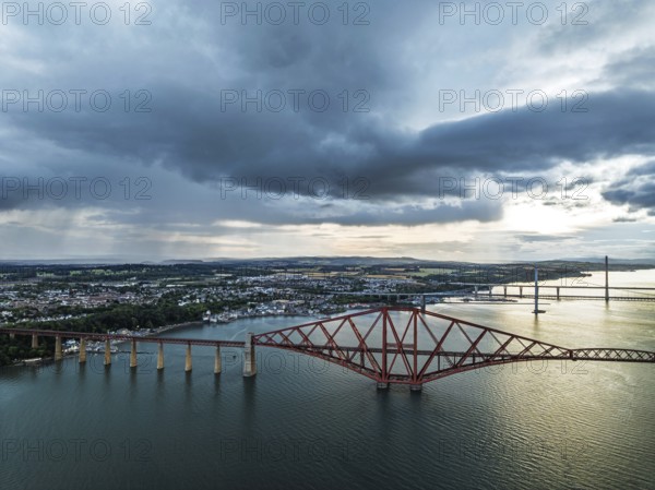 Rain clouds over Forth Bridge from a drone, Queensferry Crossing, Forth Estuary, Scotland, United Kingdom