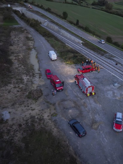 Aerial view of emergency vehicles and emergency services on railway tracks in the evening, fire brigade exercise in the new construction tunnel of the Hermann Hesse railway, Ostelsheim, Calw district, Germany