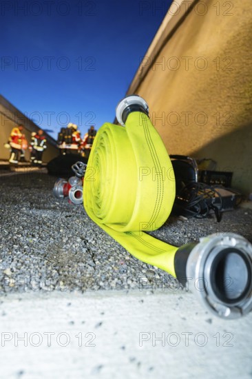 Roll-wound fire hose on the ground at night, fire drill in the new construction tunnel of the Hermann Hesse railway, Ostelsheim, district of Calw, Germany