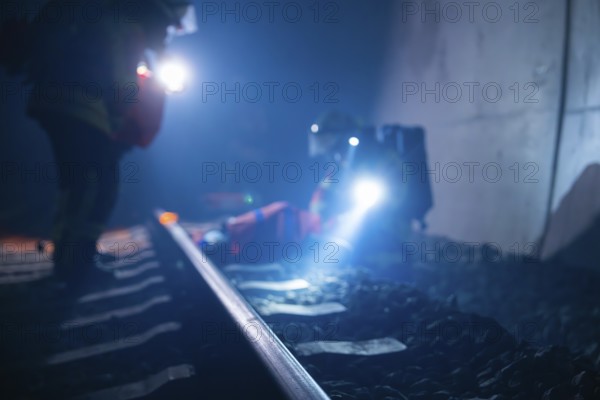 Firefighters use torches on tracks in a tunnel, firefighting exercise in the new construction tunnel of the Hermann Hesse railway, Ostelsheim, Calw district, Germany