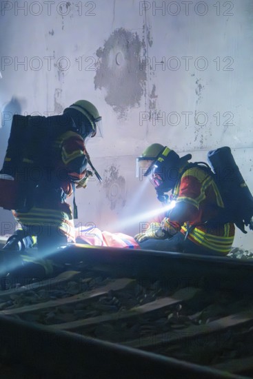 Firefighters provide first aid on tracks in a tunnel, firefighting exercise in the new tunnel of the Hermann Hesse railway, Ostelsheim, Calw district, Germany