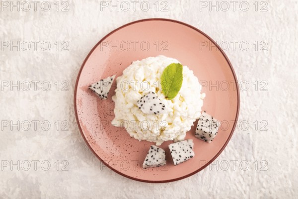 White ?ottage cheese, Curd, with Pithaya on gray concrete background, top view, flat lay, close up