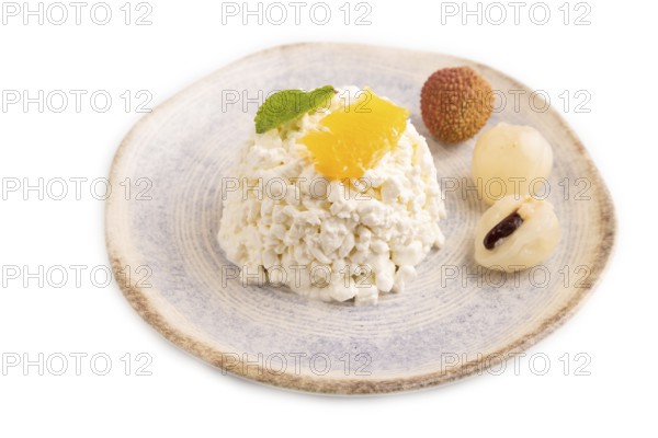 White ?ottage cheese, Curd, with orange and lychee isolated on white background, side view, close up