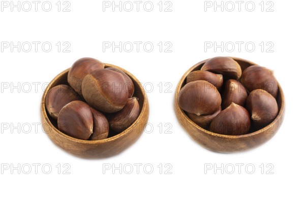Wooden bowl with raw edible ?hestnuts Isolated on white background, side view, close up, minimalism