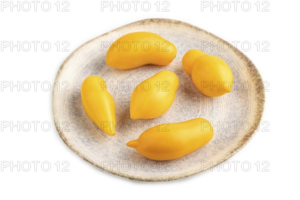 Yellow tomatoes on plate isolated on white background. Side view, close up. healthy food, vegetable, minimalism