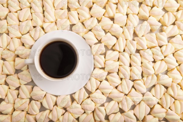 Cup of coffee on Orange and pink marshmallow background, top view, flat lay, copy space, minimalism