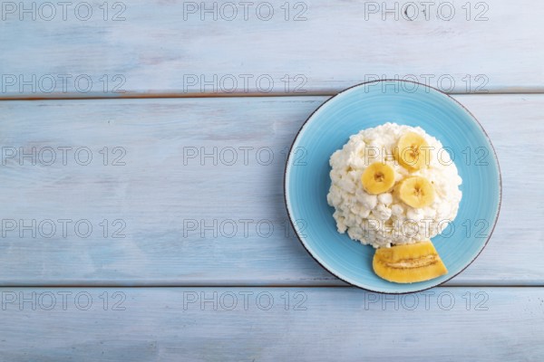 White ?ottage cheese, Curd, with Banana on blue wooden background, top view, flat lay, copy space