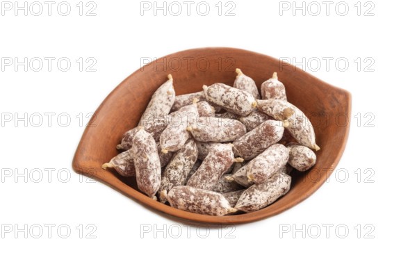 Small smoked Chicken sausages in clay bowl isolated on white background. side view, close up